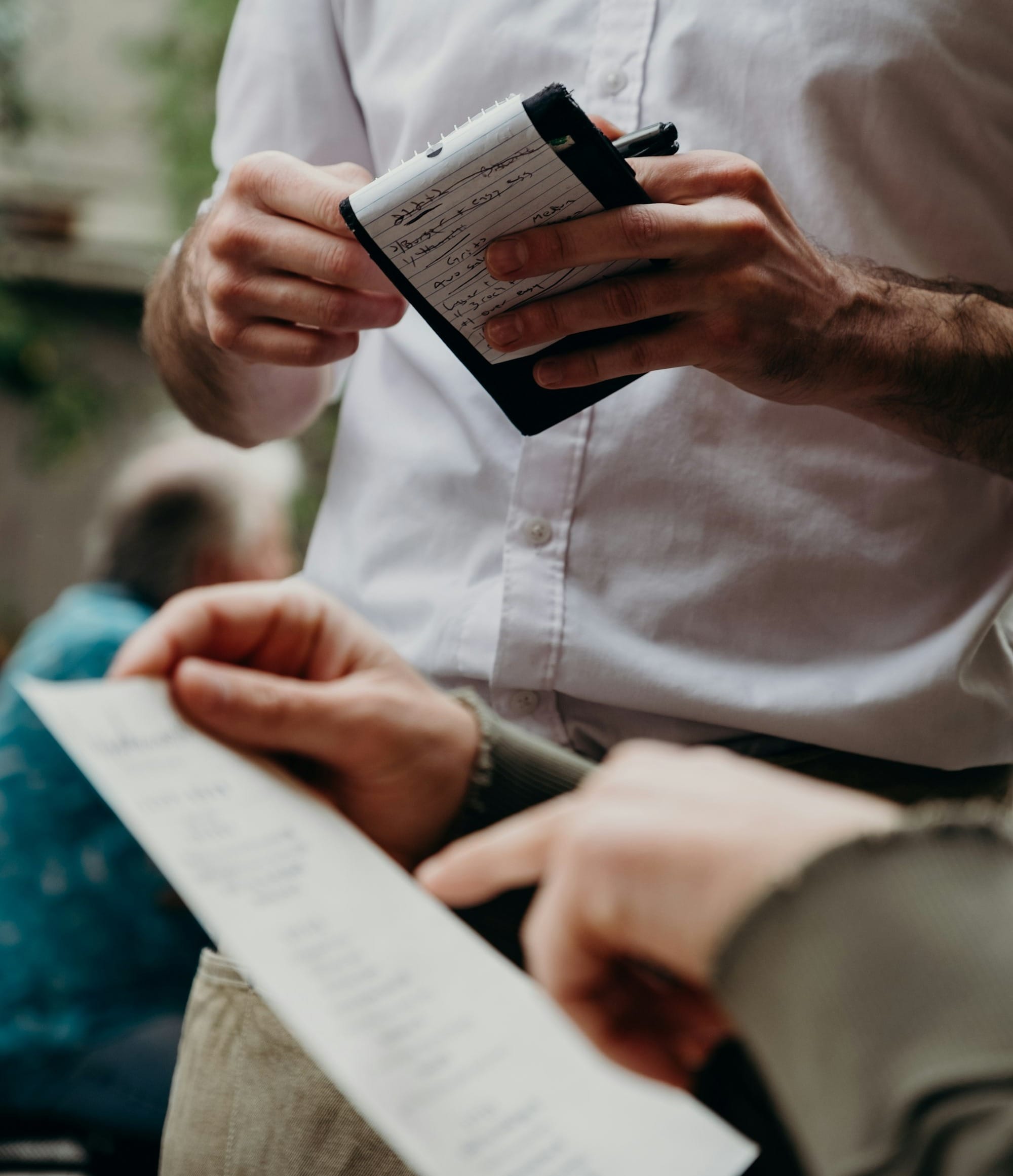 man in white button up shirt holding black and white box